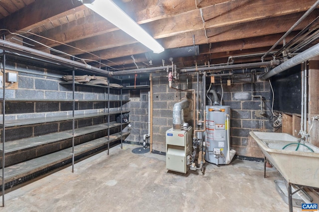 unfinished basement with water heater and a heating unit
