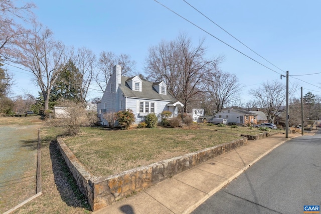 exterior space featuring a yard and a chimney