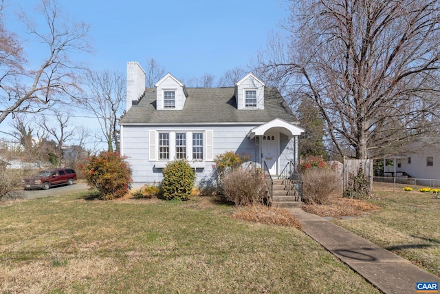 cape cod-style house featuring fence, a front lawn, and a chimney