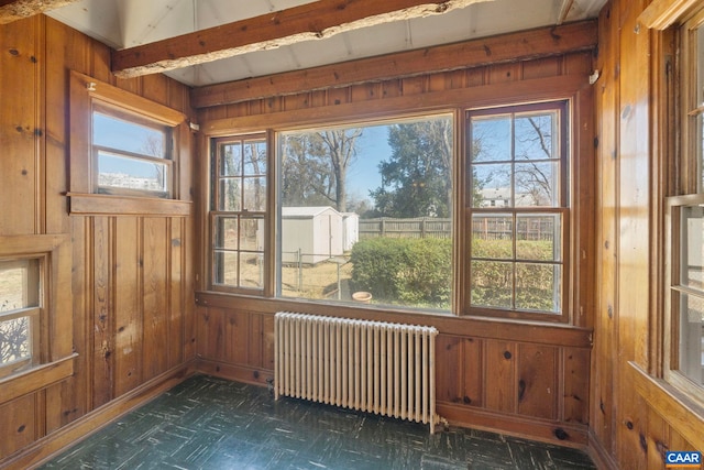 unfurnished sunroom featuring radiator heating unit