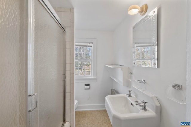 bathroom with baseboards, an enclosed shower, and toilet