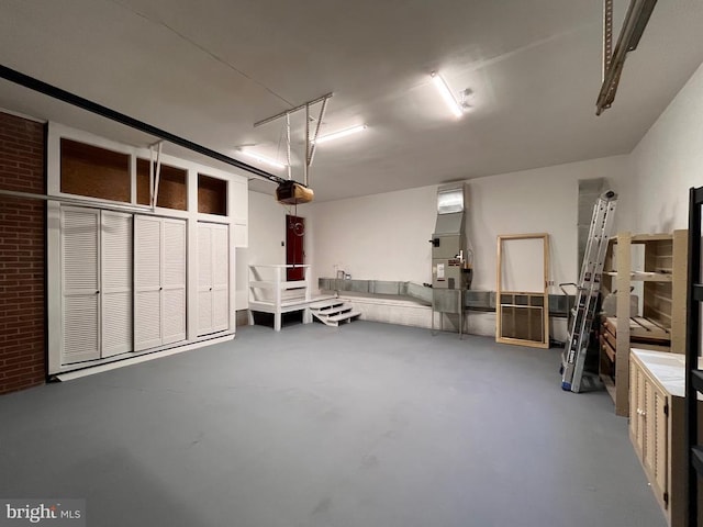 garage featuring a garage door opener and heating unit