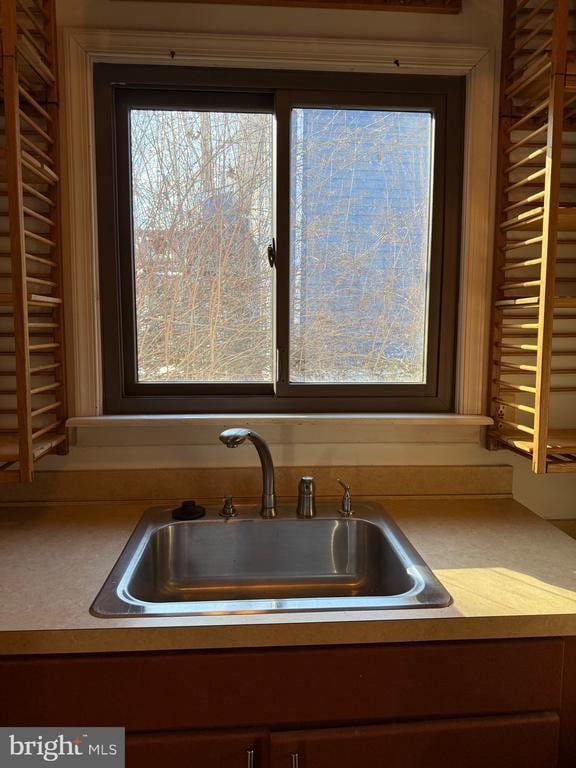 kitchen view of a sink and light countertops