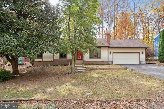 view of front facade with an attached garage, asphalt driveway, a chimney, and crawl space