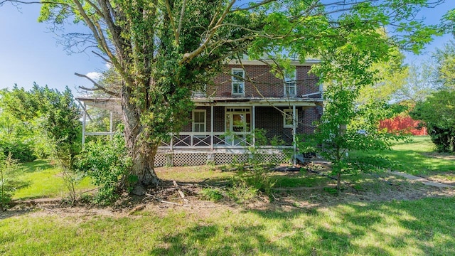 506 Williams Ave, Shenandoah, VA 22849 - view of front of home with a porch, brick siding, and a front yard