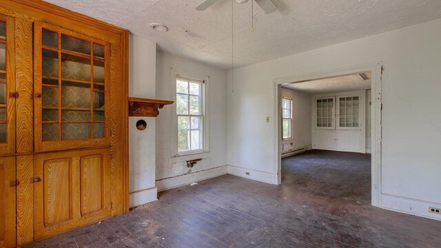 506 Williams Ave, Shenandoah, VA 22849 - unfurnished room featuring a ceiling fan, wood finished floors, a textured ceiling, baseboards, and a baseboard radiator