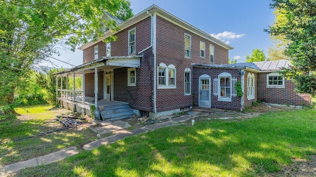 506 Williams Ave, Shenandoah, VA 22849 - view of front facade with brick siding, a front lawn, and a porch