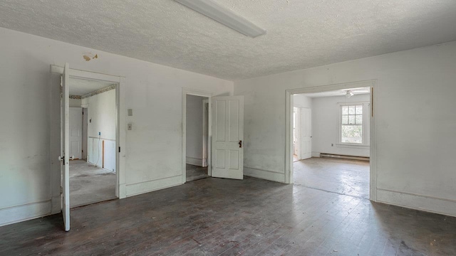 506 Williams Ave, Shenandoah, VA 22849 - unfurnished room with baseboard heating, a textured ceiling, and hardwood / wood-style floors