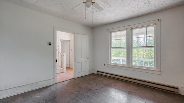506 Williams Ave, Shenandoah, VA 22849 - empty room with baseboard heating, wood finished floors, a textured ceiling, a ceiling fan, and baseboards