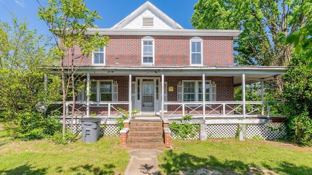 506 Williams Ave, Shenandoah, VA 22849 - view of front of home featuring brick siding, covered porch, and a front lawn