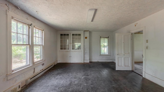506 Williams Ave, Shenandoah, VA 22849 - unfurnished room with a baseboard heating unit, a textured ceiling, dark wood-style flooring, and baseboards