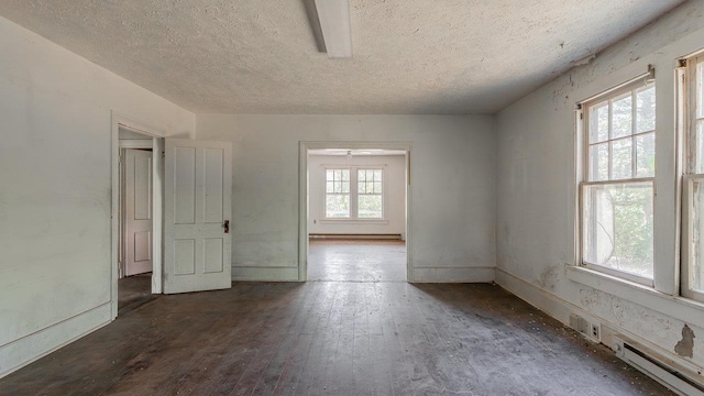 506 Williams Ave, Shenandoah, VA 22849 - spare room with baseboard heating, a textured ceiling, and hardwood / wood-style flooring