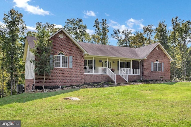 ranch-style house featuring a porch, brick siding, a front yard, and cooling unit