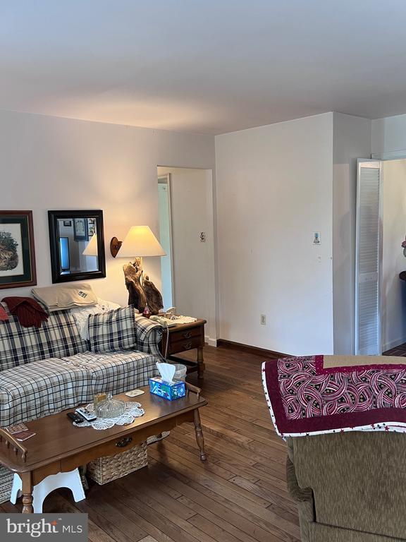  - living area featuring hardwood / wood-style flooring and baseboards