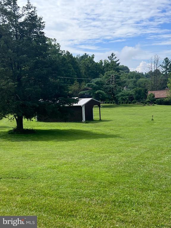  - view of green lawn with an outdoor structure and an outbuilding