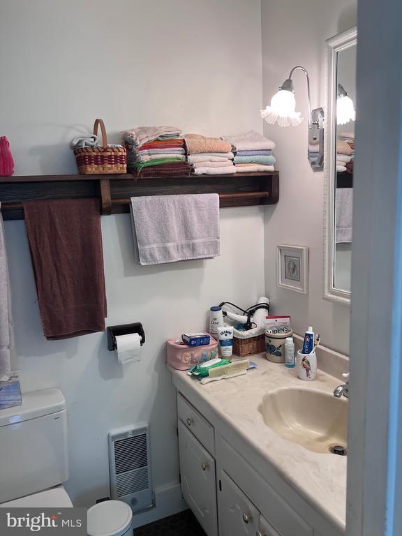  - half bath featuring vanity and heating unit