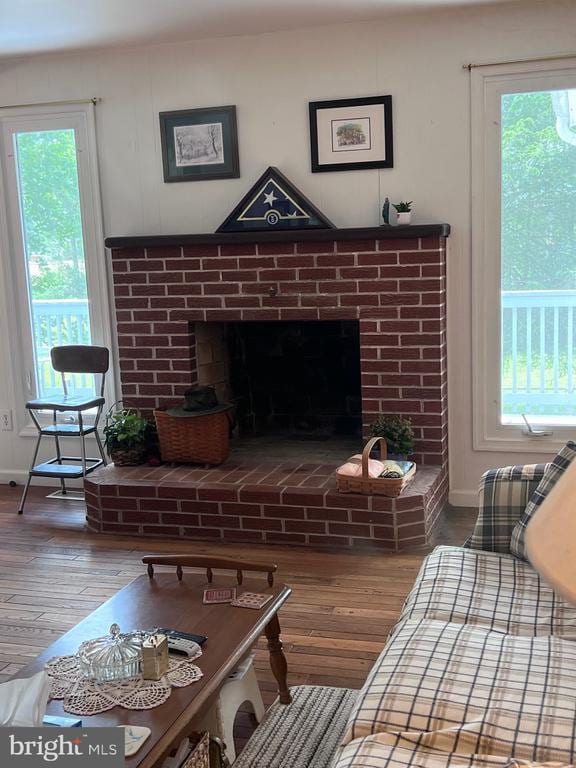  - dining area view of wood finished floors and a fireplace