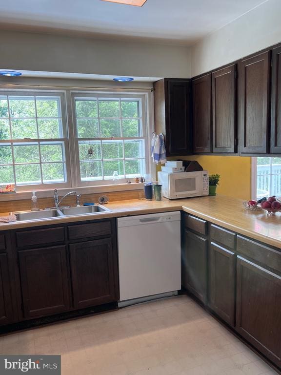  - kitchen with white appliances, light countertops, and dark brown cabinetry