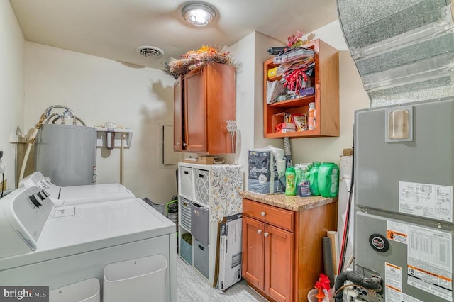 10119 Jameson Ln, Culpeper, VA 22701 - clothes washing area featuring washer and dryer, cabinet space, light wood-style floors, and water heater