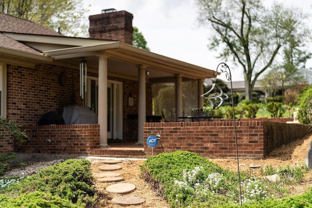 812 Meadowbrook Rd, Waynesboro, VA 22980 - entrance to property with a chimney, brick siding, a porch, and a shingled roof