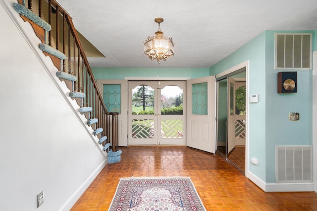 812 Meadowbrook Rd, Waynesboro, VA 22980 - entrance foyer with french doors, baseboards, stairway, a chandelier, and a textured ceiling