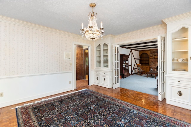 812 Meadowbrook Rd, Waynesboro, VA 22980 - unfurnished dining area featuring wallpapered walls, a chandelier, wainscoting, crown molding, and a textured ceiling
