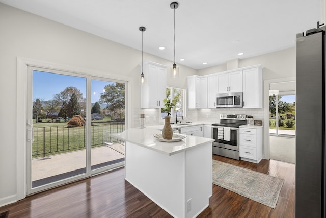 10304 Spotswood Trl, Mcgaheysville, VA 22840 - kitchen featuring appliances with stainless steel finishes, a sink, tasteful backsplash, white cabinets, and plenty of natural light