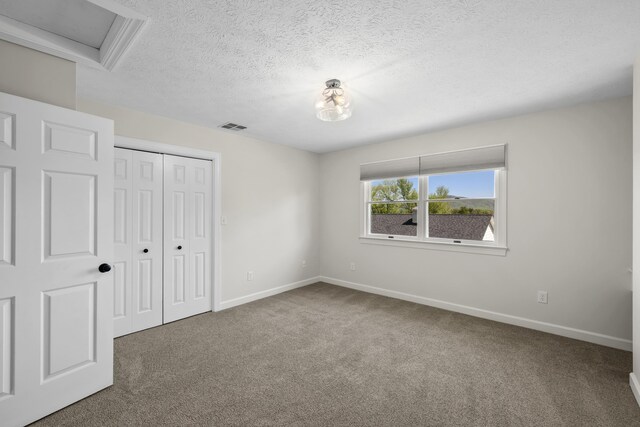 10304 Spotswood Trl, Mcgaheysville, VA 22840 - unfurnished bedroom featuring carpet flooring, baseboards, a textured ceiling, a closet, and attic access