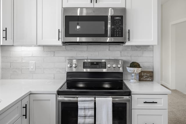 10304 Spotswood Trl, Mcgaheysville, VA 22840 - kitchen with appliances with stainless steel finishes, white cabinetry, light countertops, and carpet flooring
