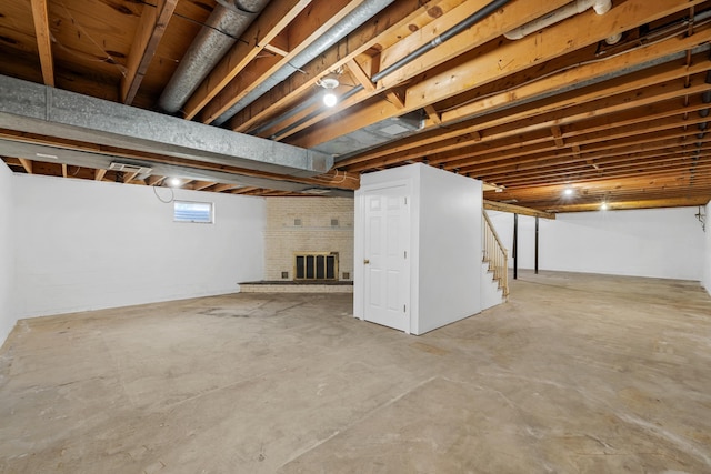 basement featuring a fireplace and stairway