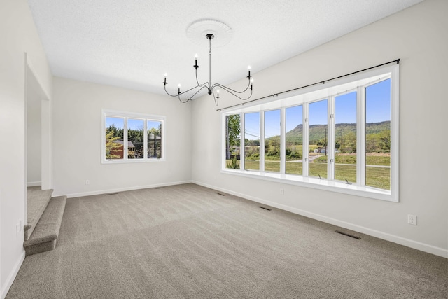 unfurnished dining area with a chandelier, carpet floors, and baseboards