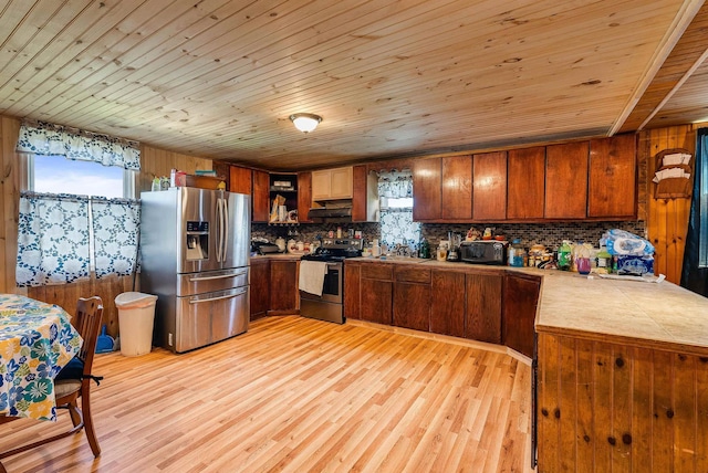 2015 Cecil Wampler Rd, Rockingham, VA 22841 - kitchen with stainless steel appliances, tile counters, wooden ceiling, decorative backsplash, and under cabinet range hood