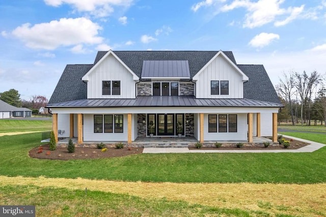  - modern inspired farmhouse with a standing seam roof, a porch, a front yard, and board and batten siding