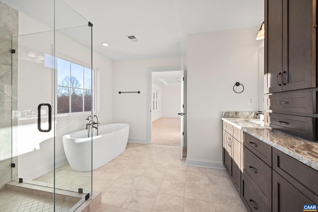 121 Yates Cir, Stanardsville, VA 22973 - bathroom with a stall shower, baseboards, visible vents, a soaking tub, and vanity