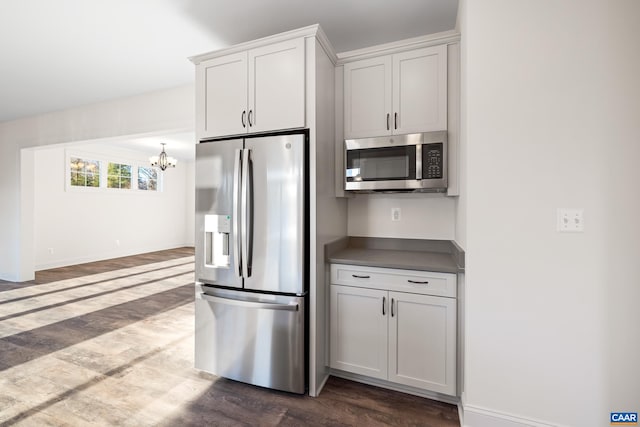121 Yates Cir, Stanardsville, VA 22973 - kitchen with baseboards, dark wood-style flooring, stainless steel appliances, and a chandelier