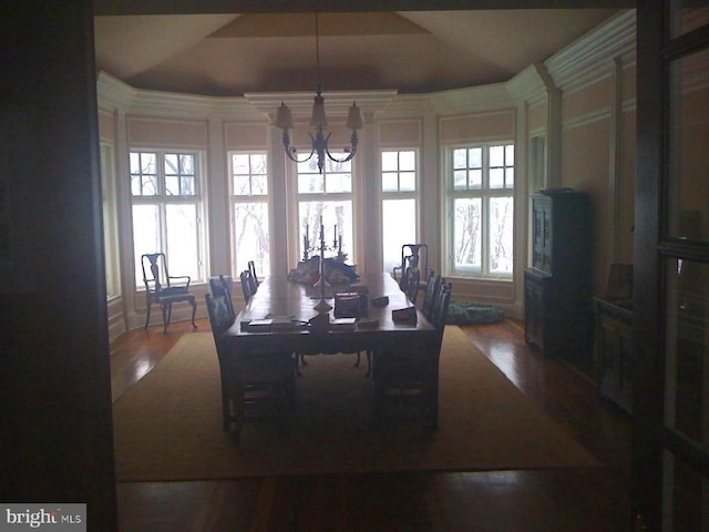  - dining space with a chandelier and wood finished floors