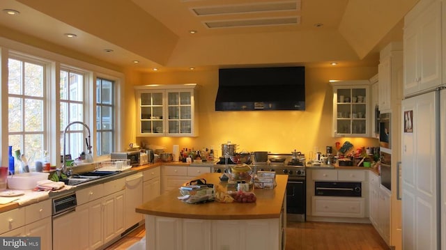  - kitchen featuring extractor fan, a sink, dishwasher, a warming drawer, and stainless steel gas range