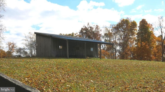  - view of pole building with a lawn