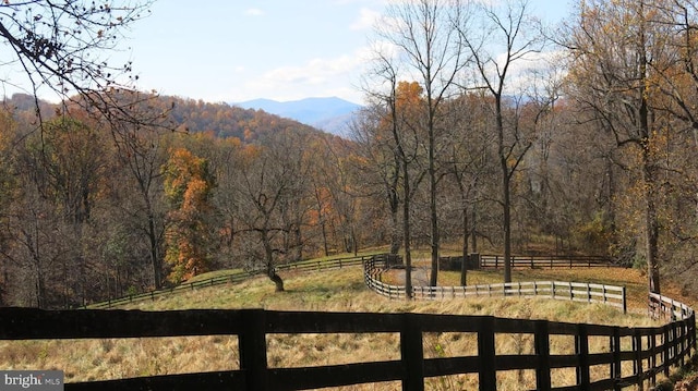  - view of yard with fence, a view of trees, a mountain view, and a view of rural / pastoral area
