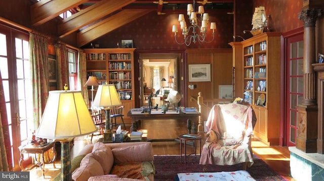  - living area featuring a chandelier, high vaulted ceiling, wood finished floors, and beamed ceiling