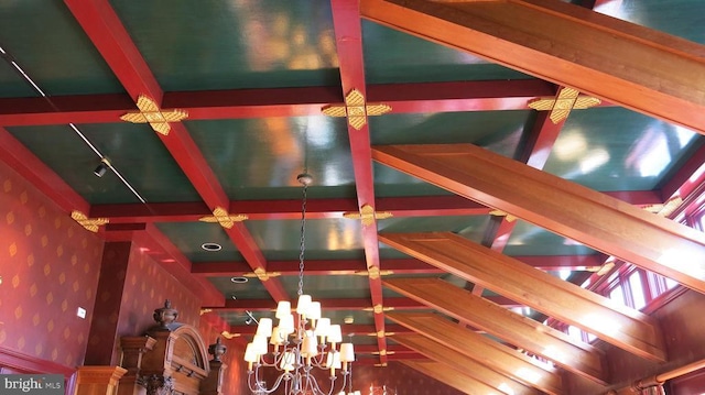  - detailed view of wallpapered walls, beamed ceiling, and a chandelier
