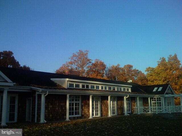  - rear view of property featuring covered porch