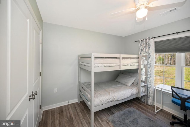 bedroom with wood finished floors, baseboards, and ceiling fan
