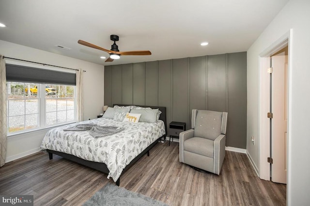 bedroom with wood finished floors, baseboards, a decorative wall, recessed lighting, and a ceiling fan