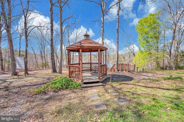 wooden terrace featuring a gazebo