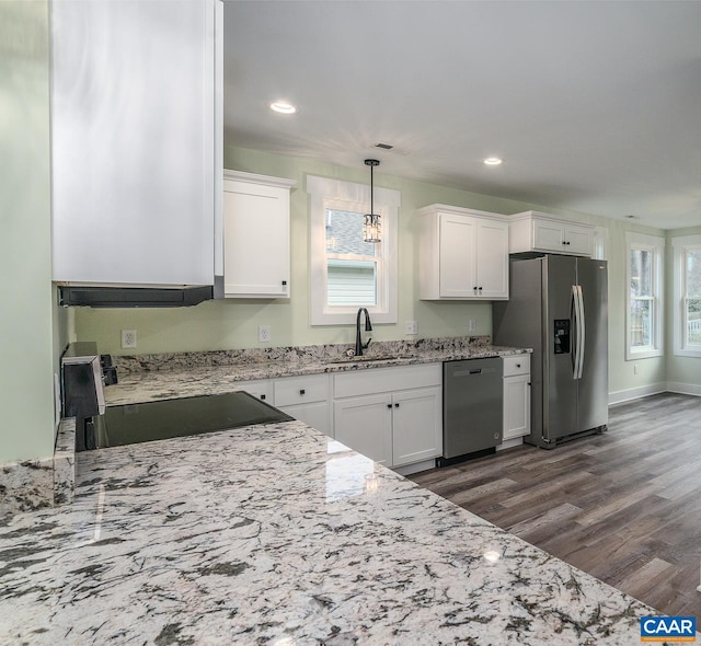 kitchen featuring white cabinets, stainless steel appliances, dark wood-style flooring, and a sink