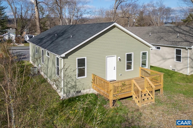 rear view of property with central AC unit, crawl space, a wooden deck, and roof with shingles