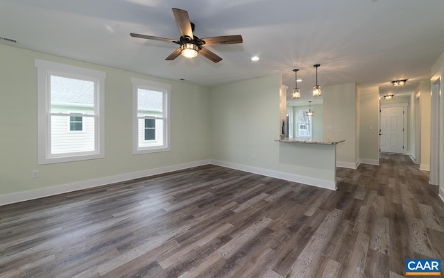 unfurnished living room with a ceiling fan, dark wood-type flooring, baseboards, visible vents, and recessed lighting