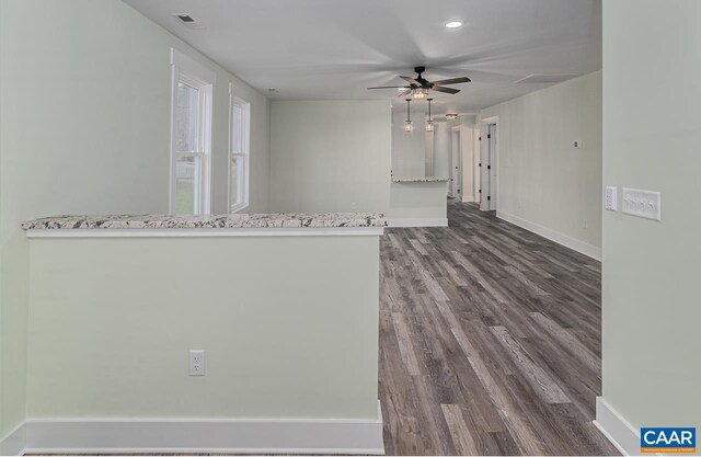 spare room with dark wood-type flooring, visible vents, recessed lighting, ceiling fan, and baseboards