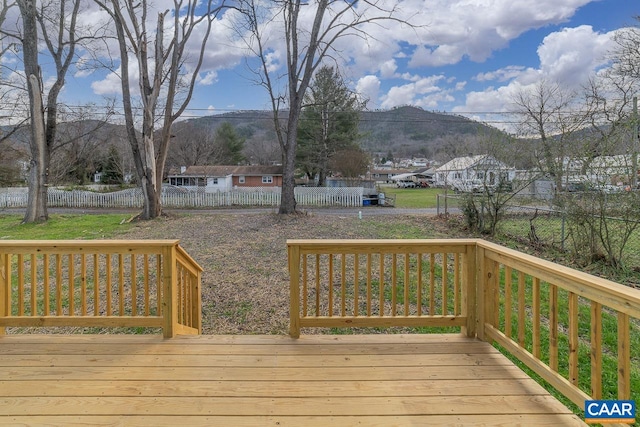 deck featuring a mountain view and fence